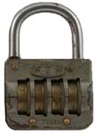 “F.T.H”. 2 1/2″ high x 1 3/4″ wide. Brass body. Steel shackle. Brass wheels. Com