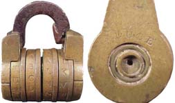 “J. DUCE”. 1 1/2″ high x 1″ wide. Brass body. Iron shackle. Brass wheels. “J. DU