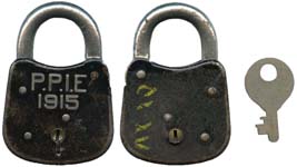 “P.P.I.E 1915” – No Period after “E”. 3 1/16″ high x 2 1/8″ wide. Steel body. Ni