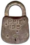 “P.P.I.E. 1915” – Period after “E”.3″ high x 2 wide. Steel body. Steel shackle.