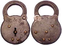 “C.&S.”. 3 3/4″ high x 2 1/2″ wide. Stamped Steel body. Steel shackle. Brass riv