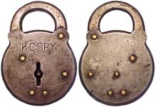 “K.C.S.R.Y.”. “Kansas City Southern Railway”. 3 1/2″ high x 2 1/2″ wide. Stamped