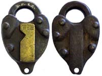 “W.F.X.C.”. 3 1/2″ high x 2 1/4″ wide. Steel body. Steel shackle. “PYES PATENT S