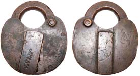 “C. SCHWEITZER NEW YORK 7”. 3 1/8″ high. Brass body. Brass shackle.