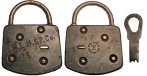 “M.L.H.&P.Co.”. 3 1/4″ high x 2 1/2″ wide. Stamped Steel body. Steel shackle. 5