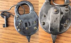 “P.O.D.”. Stamped Steel body. Steel shackle. Used on motor vehicles starting in