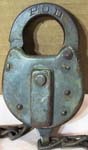 “P.O.D.”. Stamped Steel body. Steel shackle. Used on motor vehicles starting in