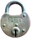 “R.F.D.” – Brass. 2 1/4″ high x 1 3/4″ wide. Brass body. Steel shackle. The reve