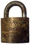 “C. & H.” – “SURFACE” – “XLCR TRADE MARK”. 2″ wide. Brass body. Steel shackle. (