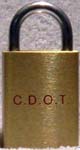 “C.D.O.T.”. Brass body. Steel shackle.
