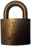 “N. T. CO” – “XLCR TRADE MARK”. 2″ wide. Brass body. Brass shackle. (S)