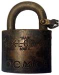 “O.C.M.CO” – “XLCR TRADE MARK”. 2″ wide. Brass body. Steel shackle. (R)