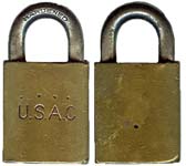 “U.S.A.C.”. 1 1/4″ wide x 1/4″ shackle diameter x 5/8″ shackle clearance. Brass