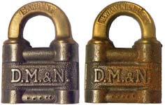 “D.M.&N.”. Steel body. Brass shackle. Keyway: Flat. The reverse of the case is t