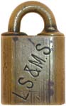 “L.S. & M.S.”. 1 1/8″ wide. Brass body. Brass shackle. The reverse of the case i