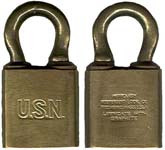 “U.S.N.”. 2 1/8″ high x 1 1/8″ wide. Brass body. Brass shackle. No Clevis. Keywa