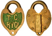 “T.C. R’YCo.”. Brass body. Brass shackle.