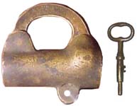 “J. L. Howard….”. 2 3/4″ high x 3″ wide. Brass body. Brass shackle. “J. L. HOW