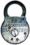 “J. W. M. Co LANCASTER, PA. SIX LEVERS” – Flat Key. 3 1/16″ high x 2″ wide. Stam