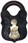 “D. M & Co”. 4 3/8″ high x 2 7/8″ wide x 13/16″ deep. Iron body. Iron shackle. T