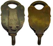 “D. M & Co”. 4″ high excluding clevis x 2 1/2″ wide x 7/8″ deep. Brass body. Iro