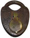 “M. W Co”. 3″ high. Iron body. Iron shackle. The reverse of the lock is blank.