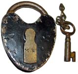 “M. W”. 3″ high x 2″ wide. Iron body. Iron shackle.
