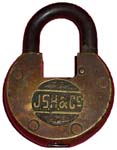 “J.S.H. & Co”. 2 3/4″ high x 2 1/8″ wide. Brass body. Steel shackle.