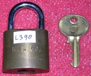 “B.E. CO.”. 2 1/2″ high x 1 1/2″ wide. Brass body. Steel shackle.