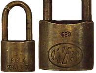 “E. A. PUBLIC SERVICE CO.”. 1 1/2″ wide. Brass body. Brass shackle. Catalog #: 6