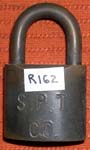 “S.P.T. CO.”. 2 1/2″ high x 1 1/2″ wide. Brass body. Brass shackle.