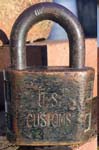 “U.S. CUSTOMS”. 2″ wide x 3/8″ shackle diameter. Brass body. Steel shackle. ‘A’